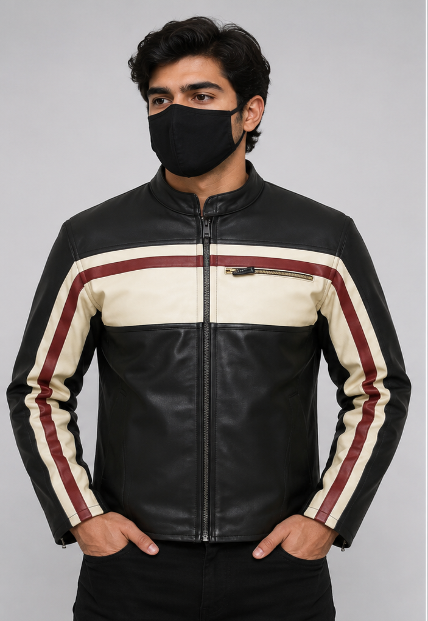 A man wearing a black leather motorcycle jacket with cream and Maroon color-blocked stripes on the chest and sleeves, paired with a black face mask, against a solid gray studio background.