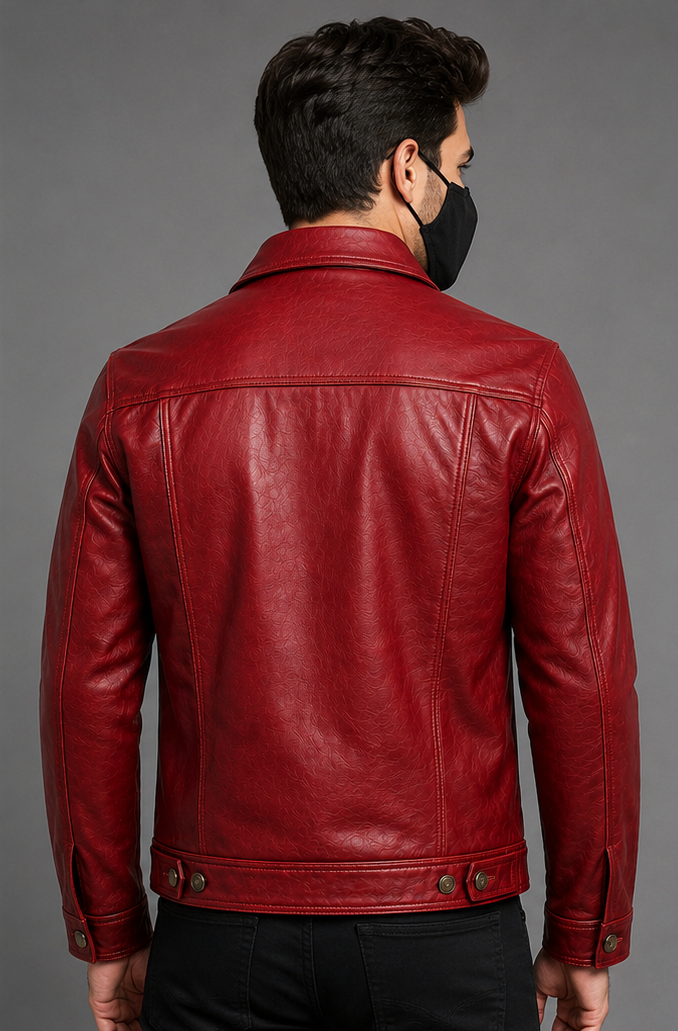 A man viewed from the back wearing a red leather trucker jacket and a black face mask, set against a solid gray studio background.