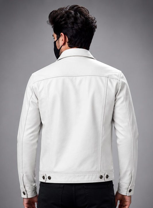 A man viewed from the back wearing a white leather trucker jacket and black pants against a solid gray studio background.