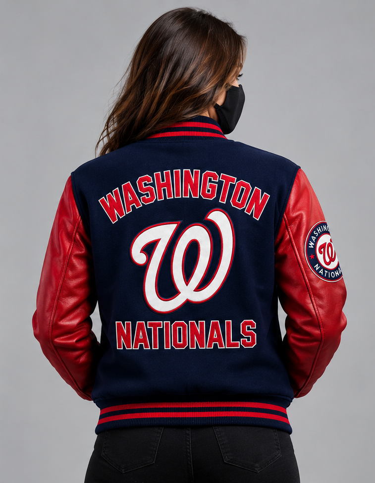 A woman viewed from behind wearing a navy and red Washington Nationals varsity jacket with 'WASHINGTON NATIONALS' and a large 'W' embroidered on the back.