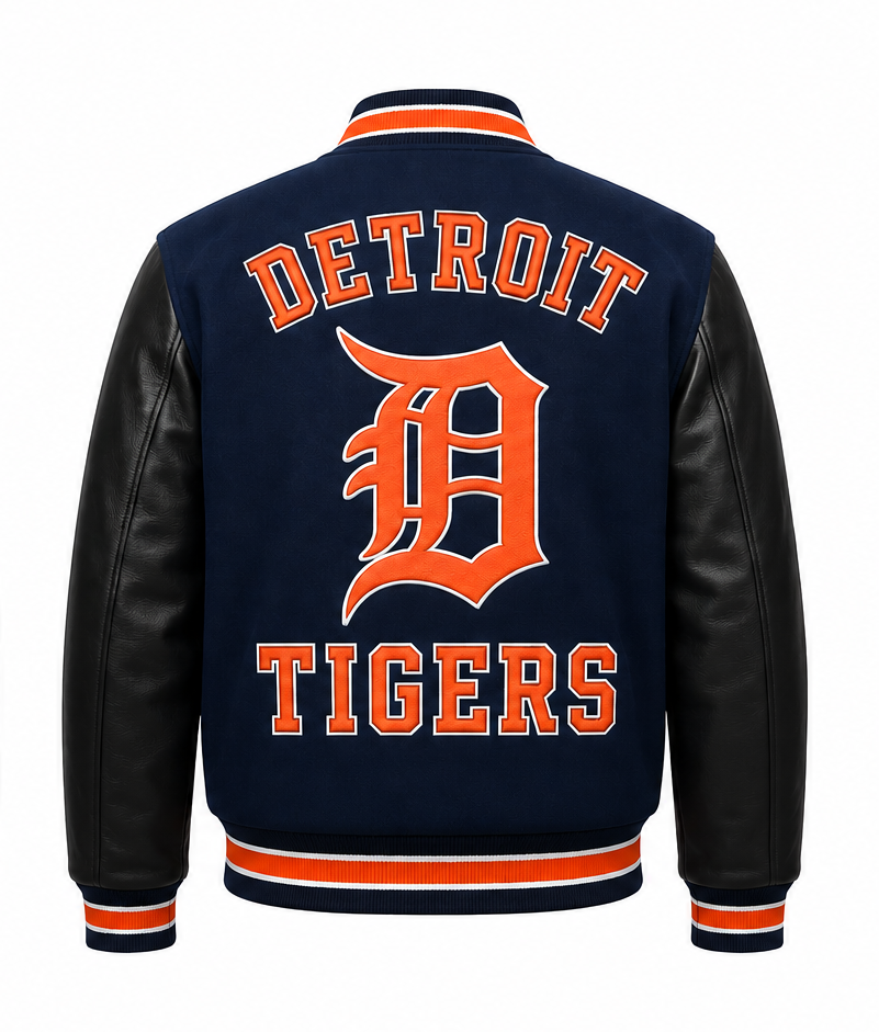 Detroit Tigers varsity jacket shown from the back, featuring a navy blue fleece body, black faux leather sleeves, and orange and white lettering.