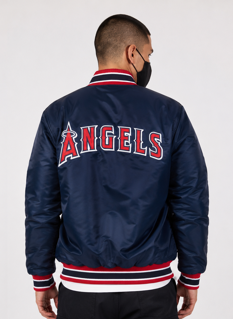 A man viewed from the back wearing a navy blue satin bomber jacket with 'ANGELS' in red and white lettering across the back, featuring red and white striped ribbed collar, cuffs, and hem.