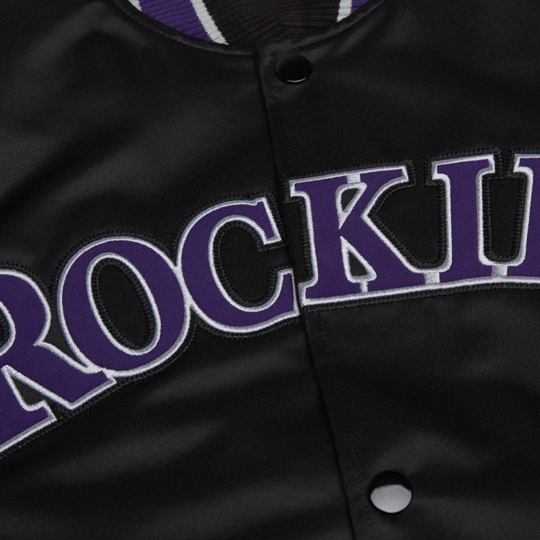 Black jacket with purple text 'ROCKIES' on a close-up view