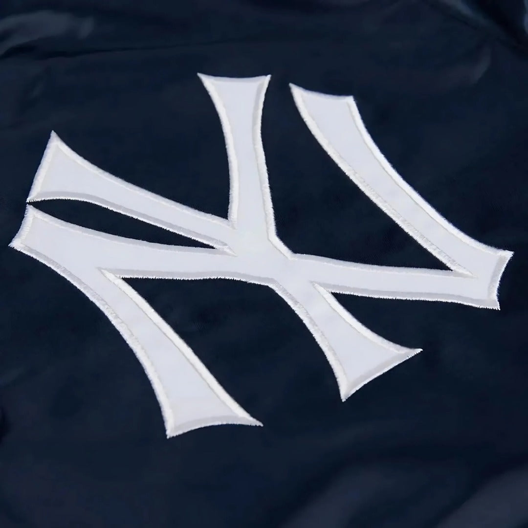 Close-up of a white "NY" logo on a dark blue background