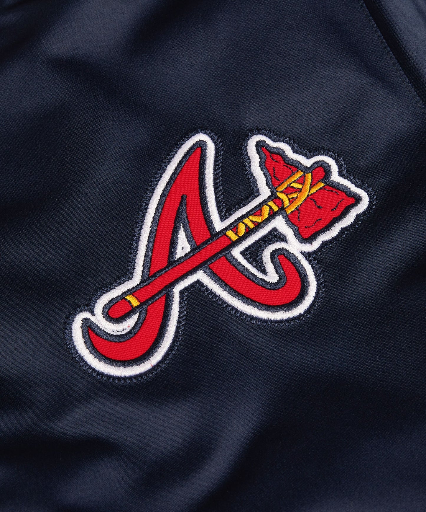 Close-up of a red and white logo on a dark blue background