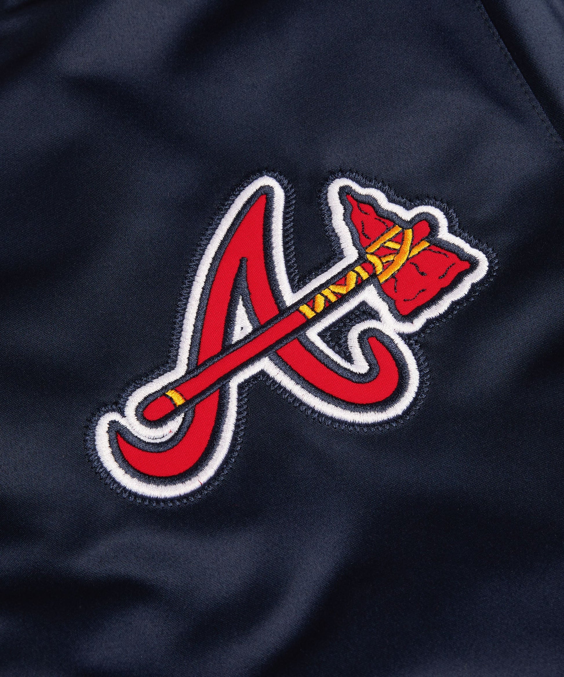 Close-up of a red and white logo on a dark blue background