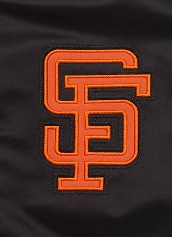 Close-up of a dark brown fabric item with a large orange-embroidered interlocking SF logo patch.