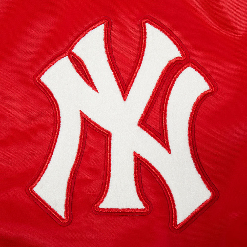 Close-up of a red jacket with a white "NY" logo on a red background