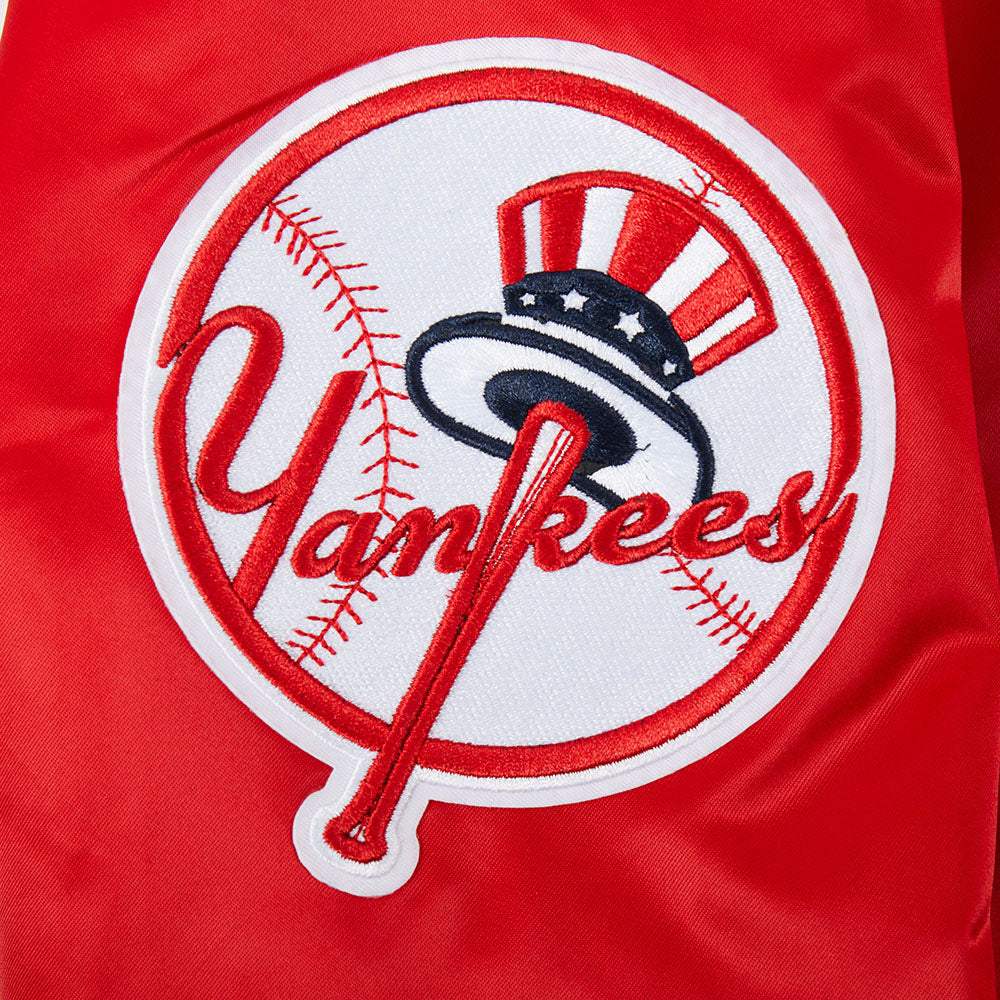 Close-up of a red jacket with a Yankees logo on a red background
