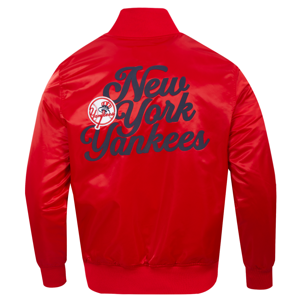 A red satin bomber jacket shown from the back, featuring a large navy blue 'New York Yankees' script logo and the team crest on the back.
