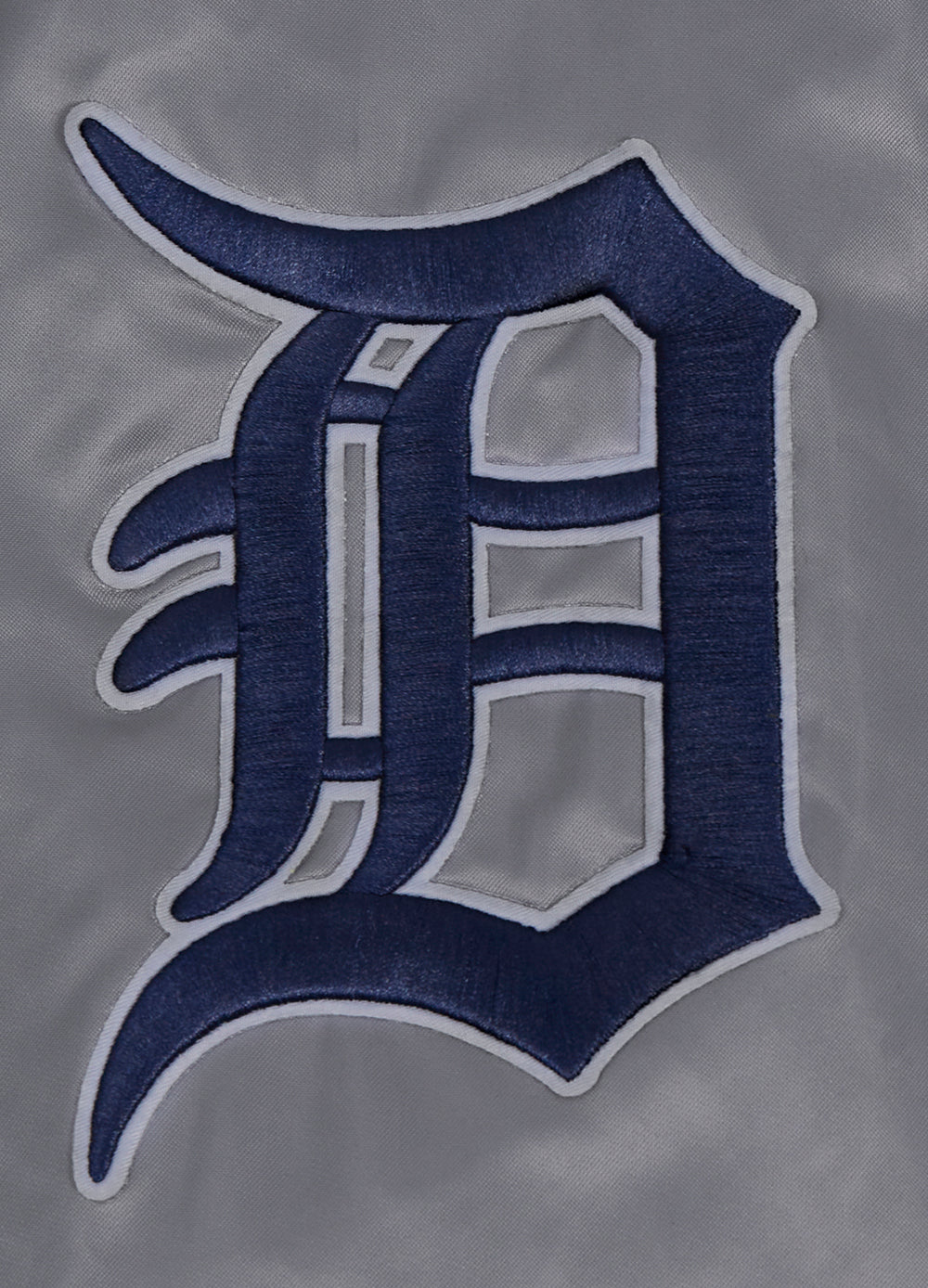 Embroidered Navy blue 'D' logo on a gray background