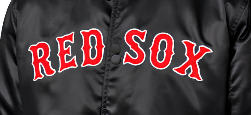 Close-up of a black satin jacket with 'RED SOX' embroidered in red with a white outline across the chest.