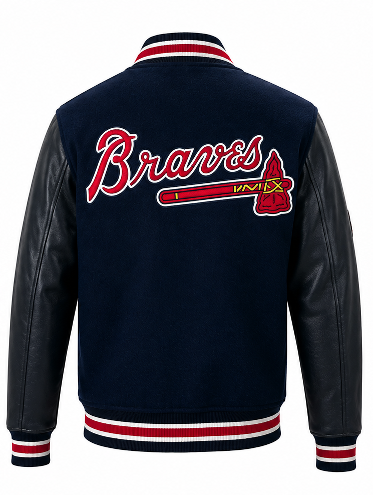 Back view of a navy blue varsity jacket with black faux-leather sleeves, featuring 'Braves' in red script with a white outline and a red and gold tomahawk graphic on the back, finished with red, white, and navy striped ribbing.