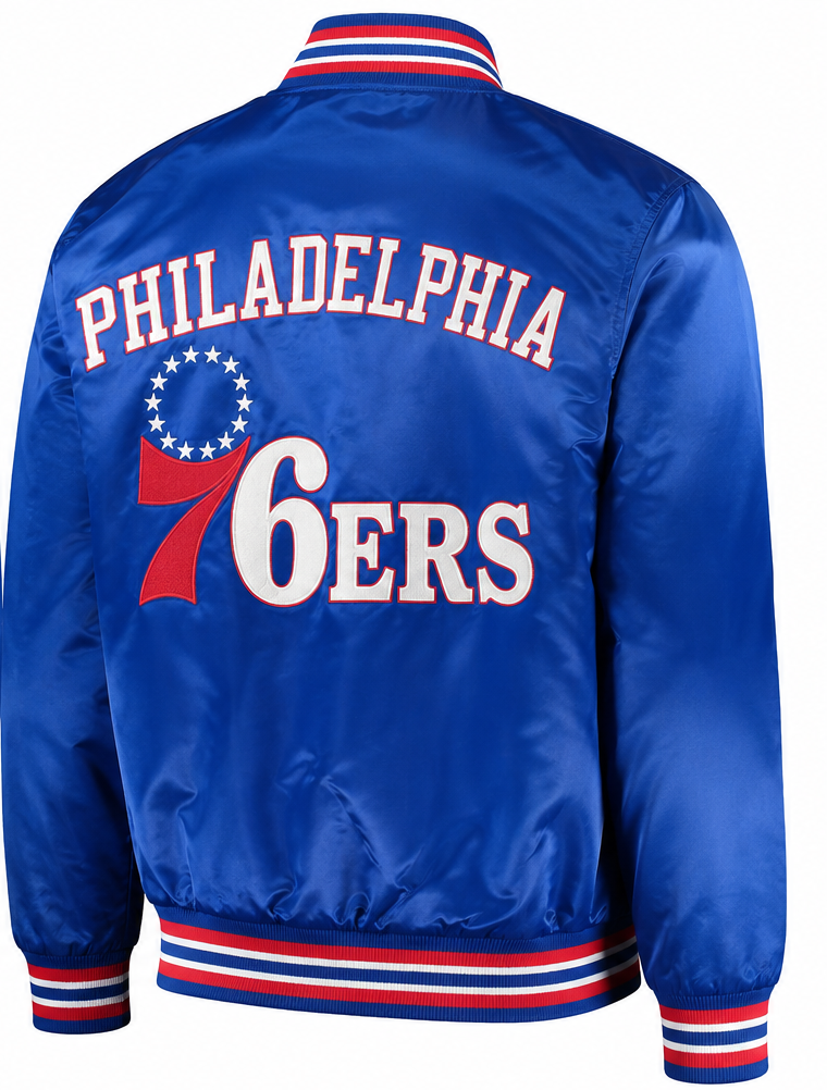 A royal blue satin Philadelphia 76ers varsity jacket shown from the back, featuring 'PHILADELPHIA 76ERS' in white and red lettering with a red and white ribbon motif.