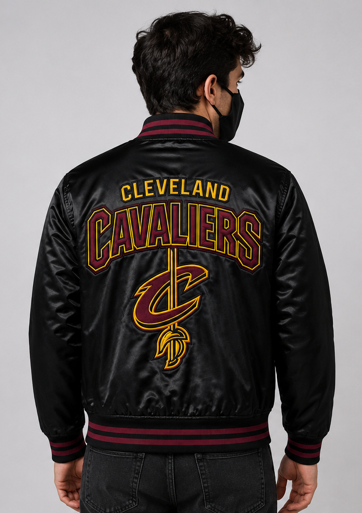 A man viewed from behind wearing a black satin bomber jacket with 'CLEVELAND CAVALIERS' and the team logo embroidered in maroon and gold on the back.