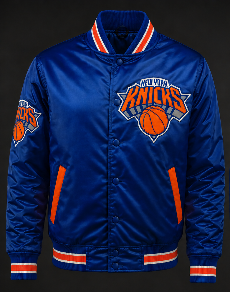 A royal blue satin New York Knicks varsity-style jacket with orange and white striped ribbed collar, cuffs, and hem, featuring the team logo on the chest and sleeve.