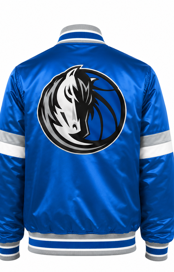 A blue satin bomber jacket shown from the back, featuring a large circular Dallas Mavericks horse logo in black, white, and gray. The jacket has white and gray striped ribbed trim at the collar, cuffs, and hem, with white reflective stripes on the sleeves.
