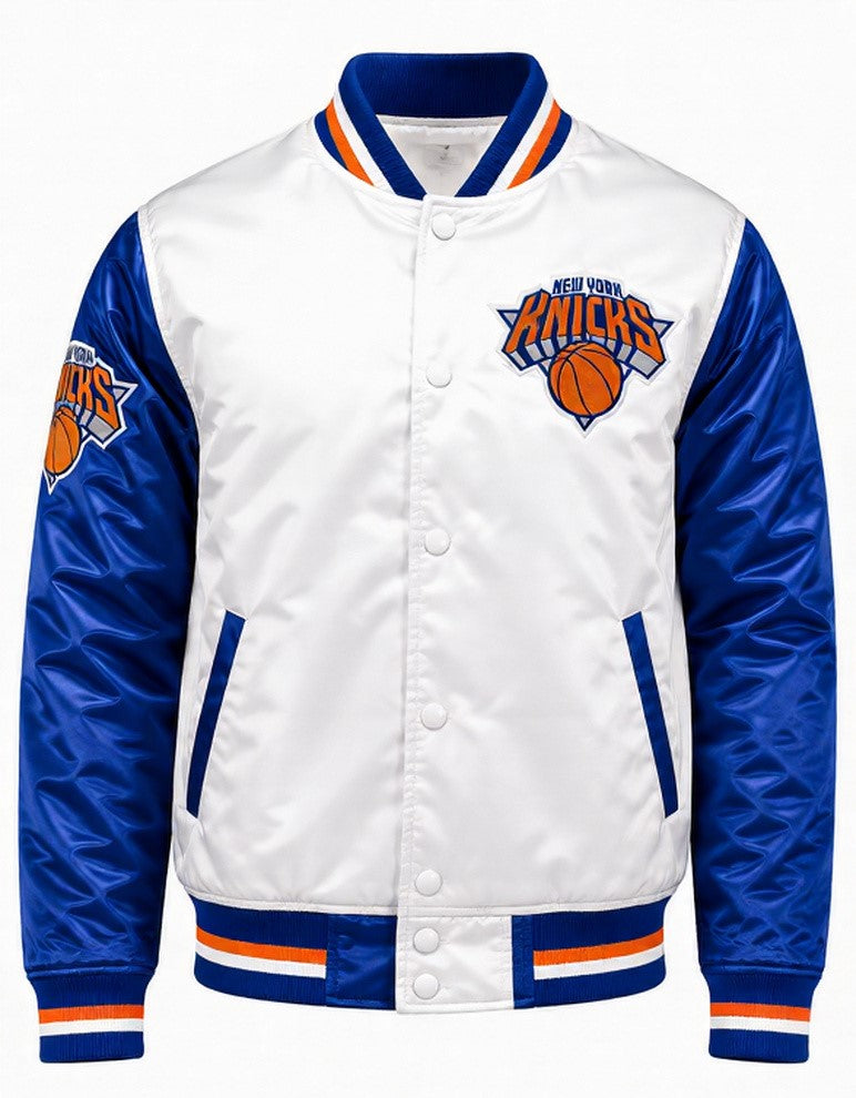 A New York Knicks satin bomber jacket with a white body, royal blue sleeves, and orange and white striped ribbed trim on the collar, hem, and cuffs. The front features a button closure and the Knicks logo on the left chest.