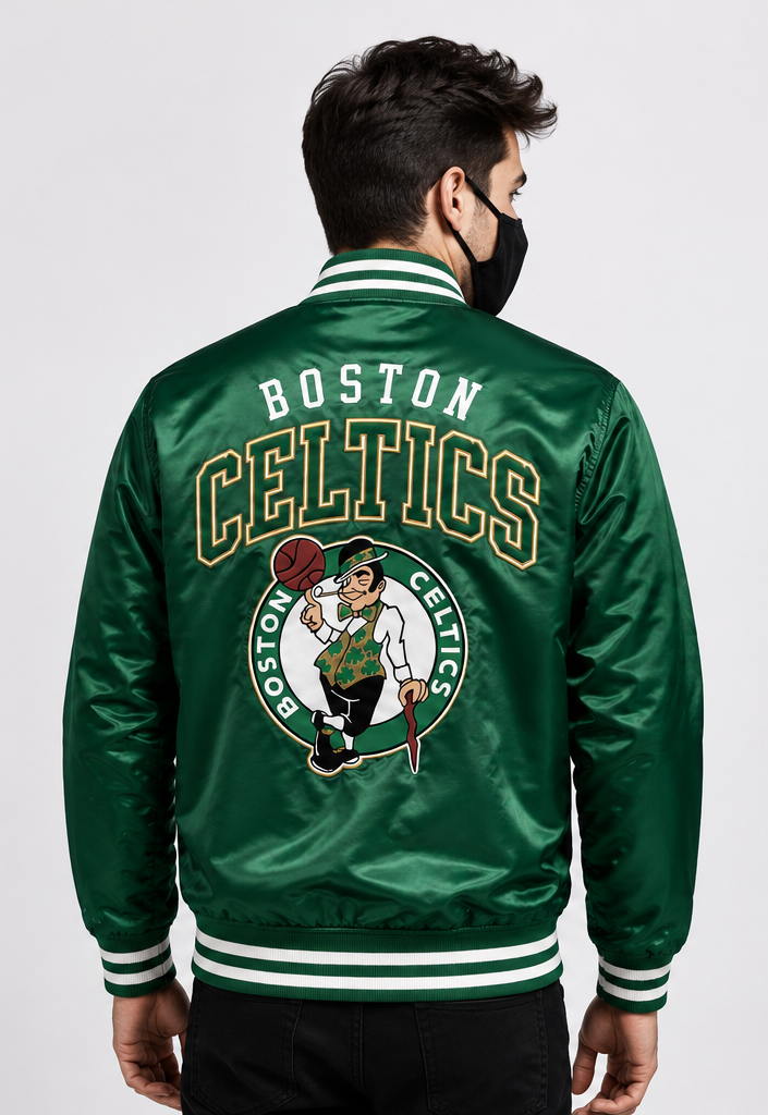 A man wearing a green Boston Celtics satin bomber jacket, viewed from the back. The jacket features a large embroidered Boston Celtics logo and 'BOSTON CELTICS' text on the back, with white and green striped ribbed collar, cuffs, and hem.