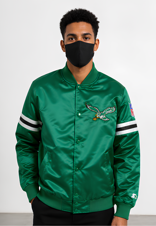 Person wearing a Philadelphia Eagles green satin jacket with a logo on a white background