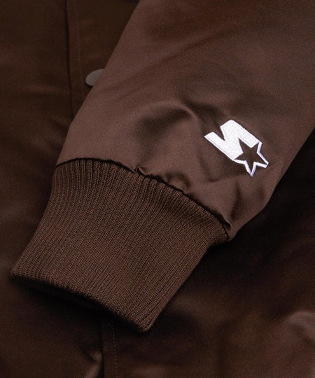 Cleveland Browns: Close-up of a brown jacket with a white logo on the sleeve.