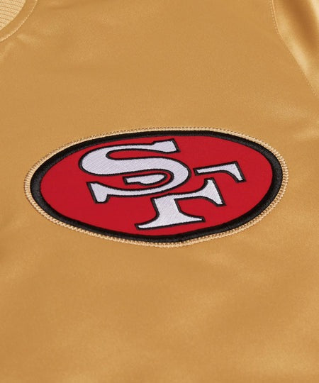 Close-up of a San Francisco 49ers logo on a gold background