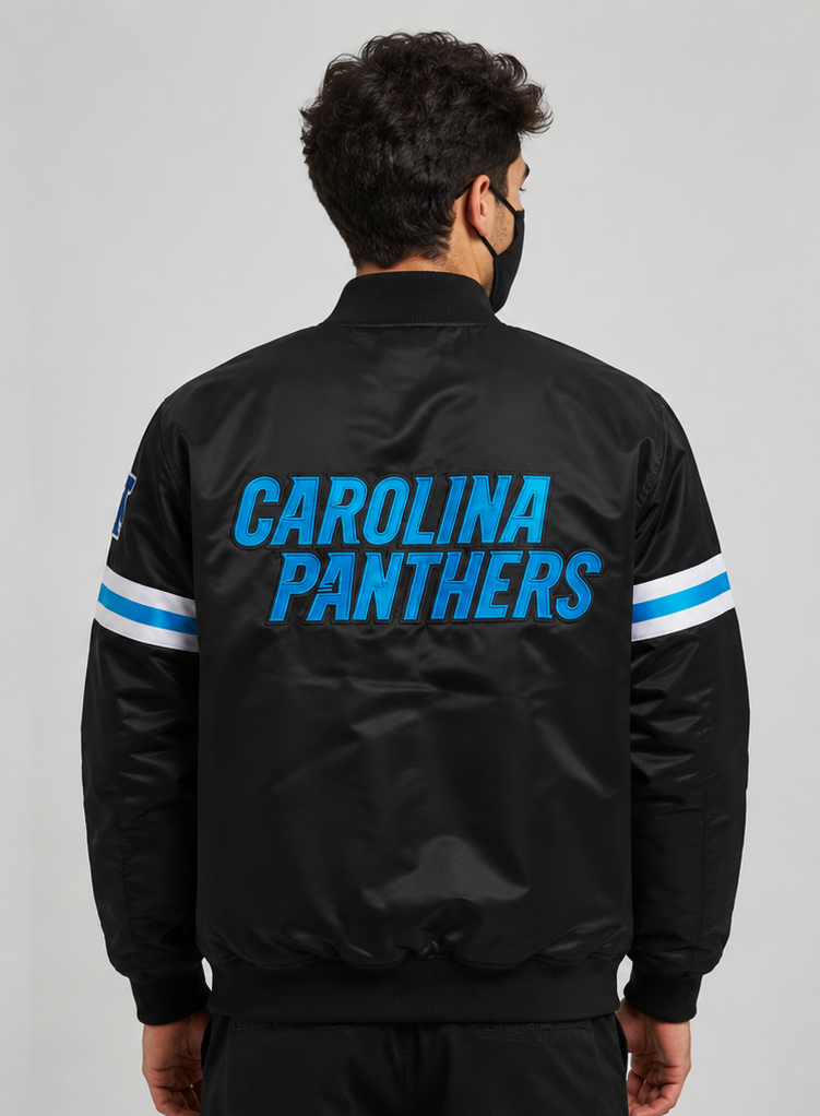 Person wearing a black Carolina Panthers jacket with blue and white text on a gray background