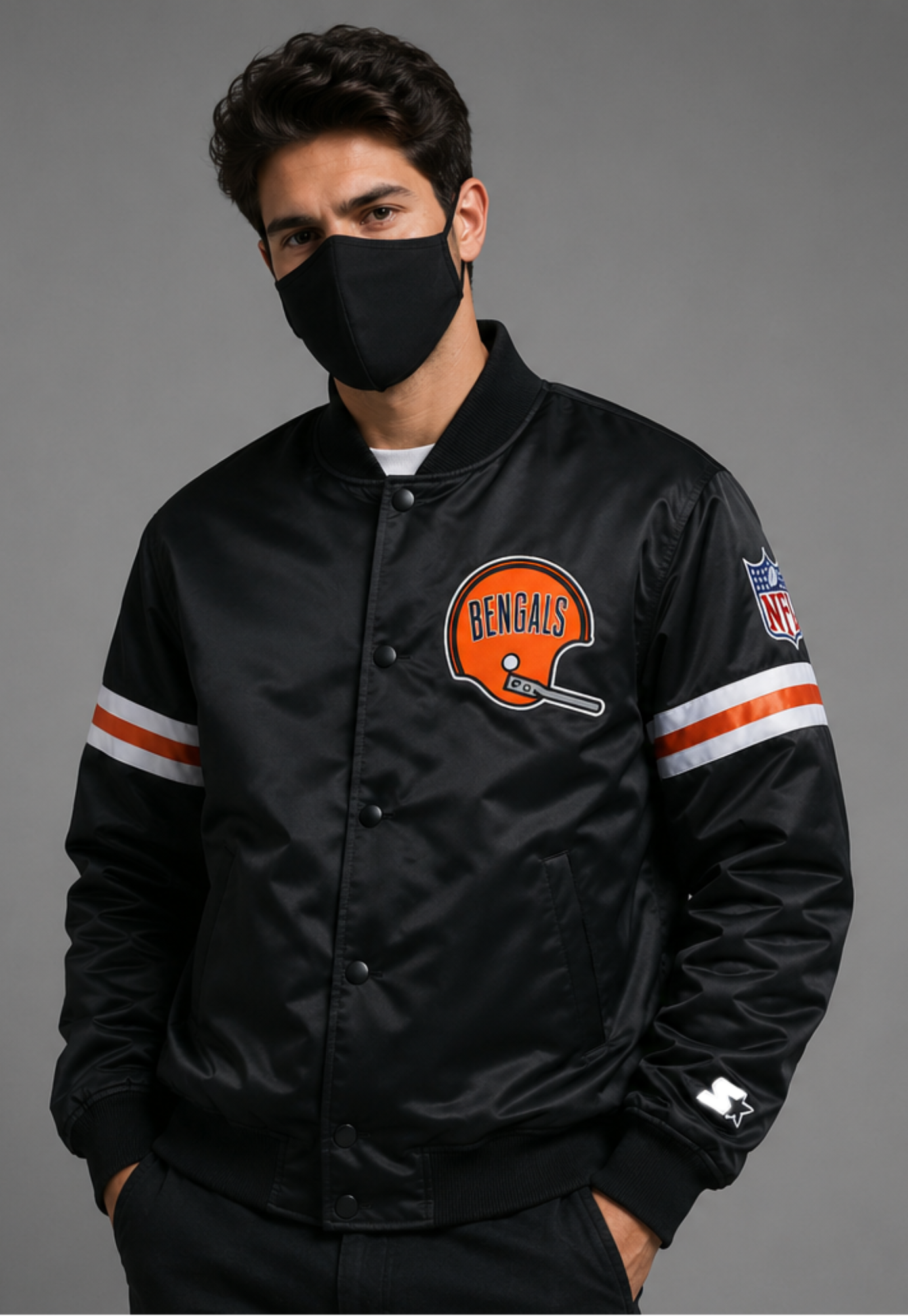 Person wearing a Cincinnati Bengals black jacket with a Bengals logo on a gray background