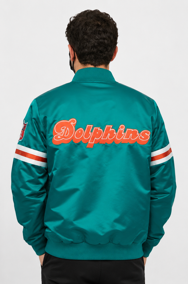 Person wearing a Miami Dolphins Turquoise jacket with 'Dolphins' text on the back against a white background
