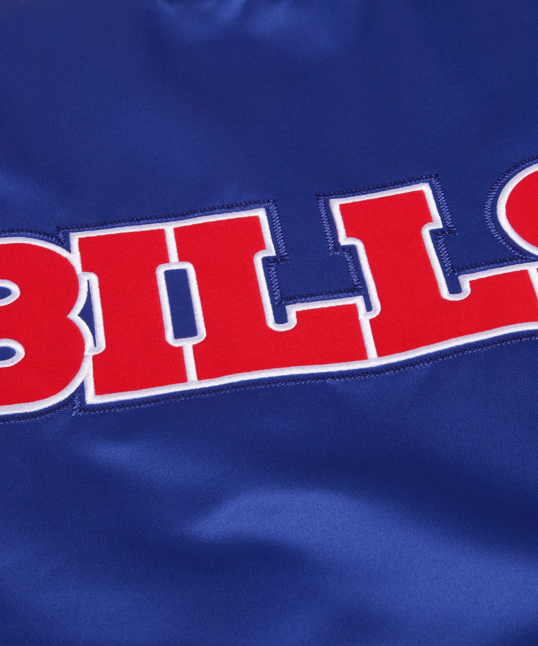 Close-up of a blue fabric with red and white text spelling 'BILLS'.