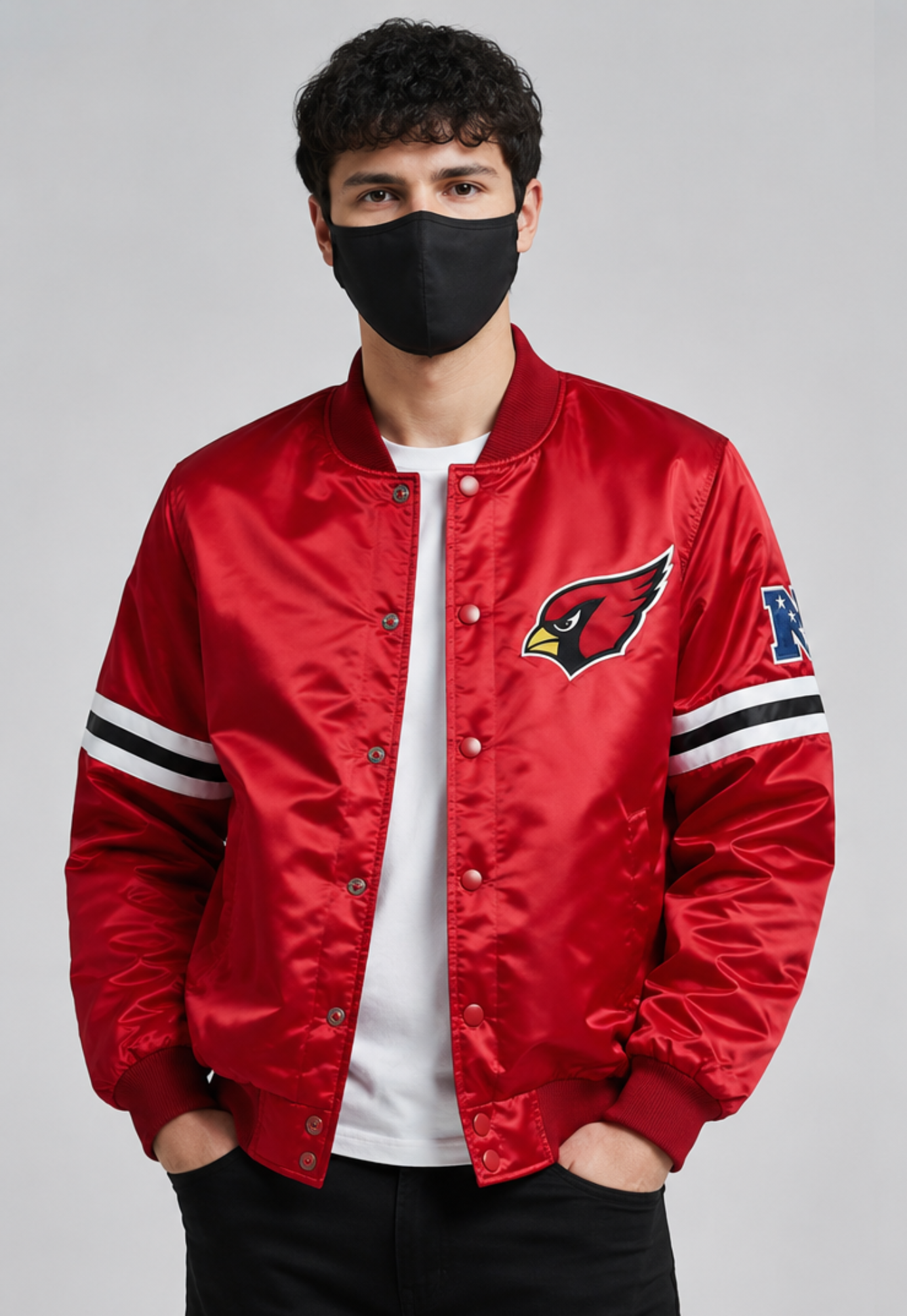 Person wearing an Arizona Cardinals red satin jacket with a logo on a gray background