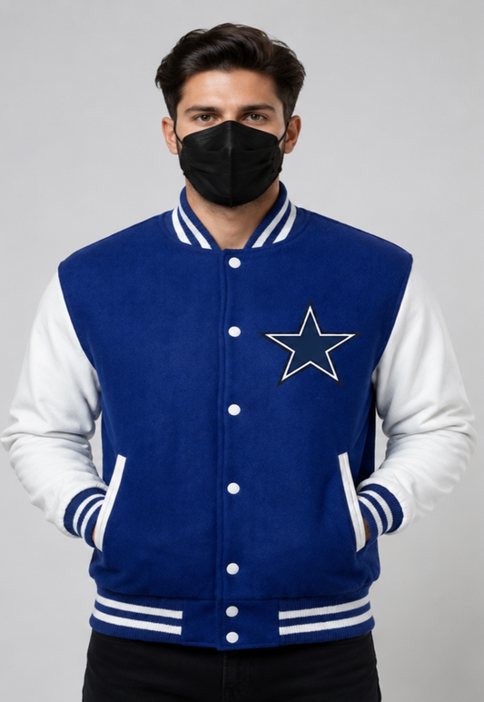 A man wearing a Dallas Cowboys varsity jacket with a blue fleece body and white sleeves, featuring the embroidered star logo on the chest.