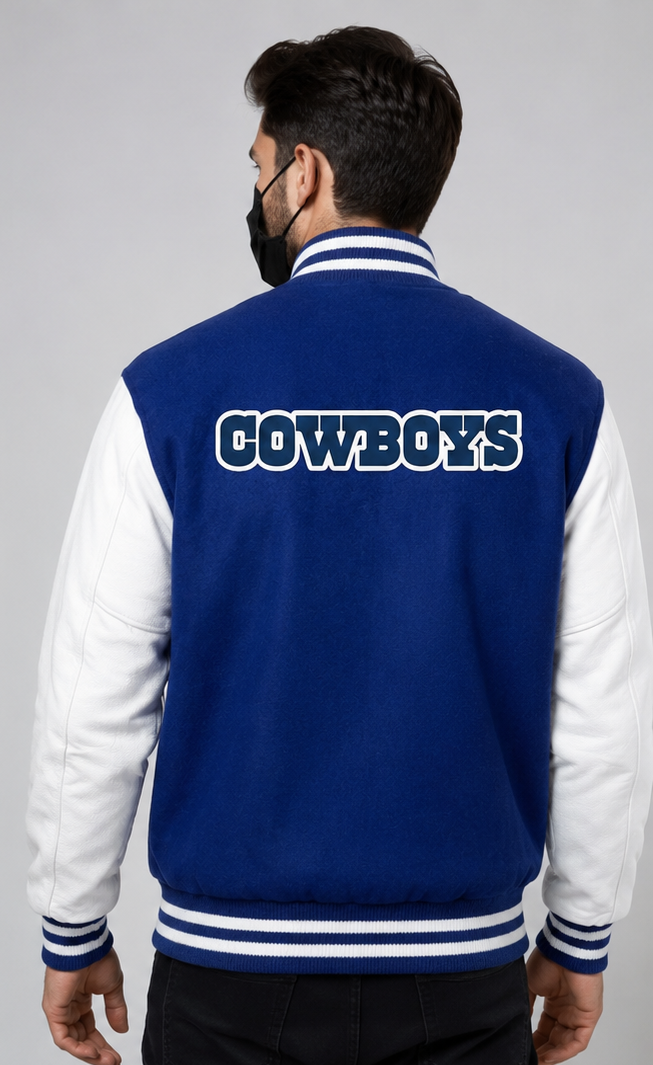 A man viewed from the back wearing a royal blue and white varsity jacket with 'COWBOYS' embroidery across the upper back in white letters with a blue outline.