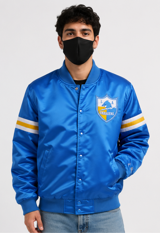 A man wearing the Los Angeles Chargers Royal Blue Jacket with team logos and a white background