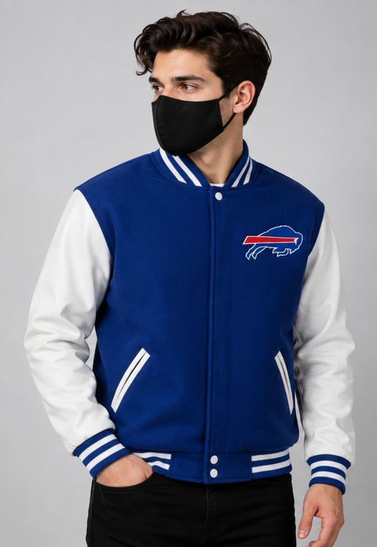A man wearing a blue and white varsity jacket with the Buffalo Bills logo on the chest, paired with a black face mask and black pants, photographed against a neutral gray background.