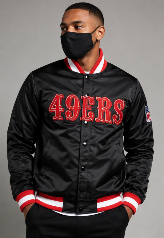A Men Wearing the San Francisco 49ers Black Satin Jacket with grey background