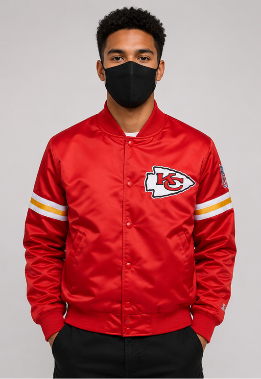 A Men Wearing the Kansas City Chiefs Red Satin Jacket with team logos with grey background