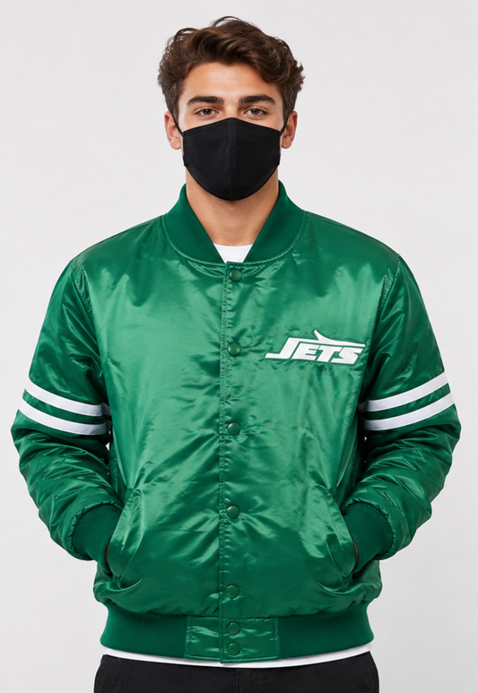 Person wearing a green 'Jets' jacket with a black face mask on a white background