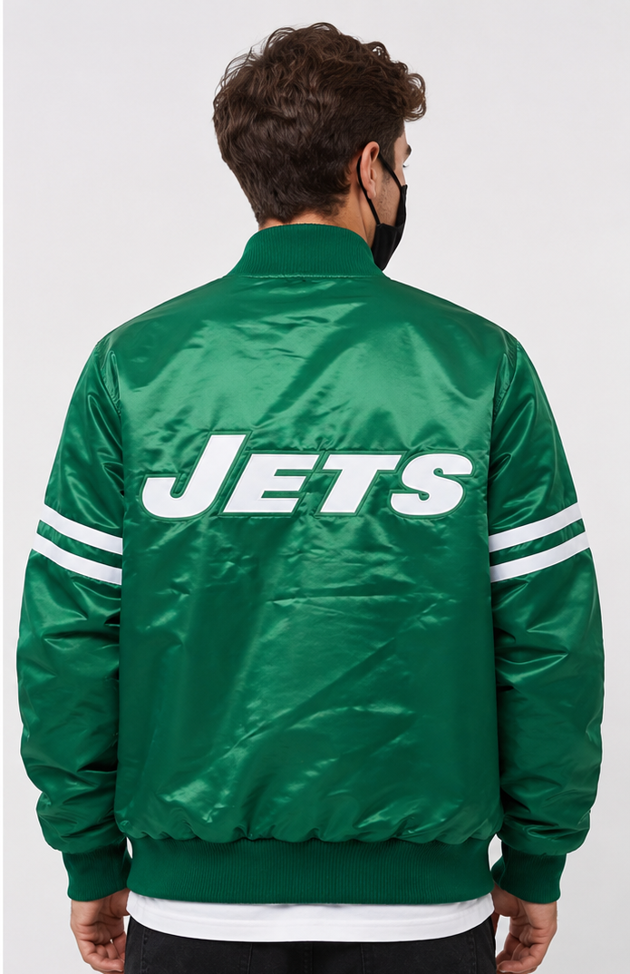 Person wearing a green 'Jets' jacket with white lettering on a plain background