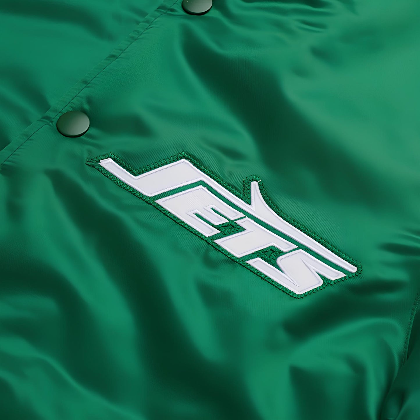 Green jacket with 'JETS' logo on a close-up view