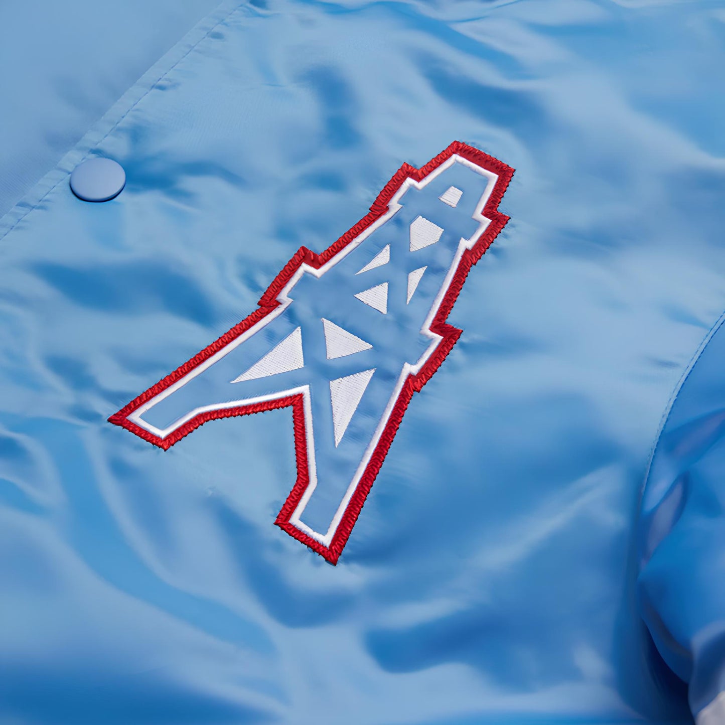 Blue jacket with a Houston Oilers red and white logo on a blue background