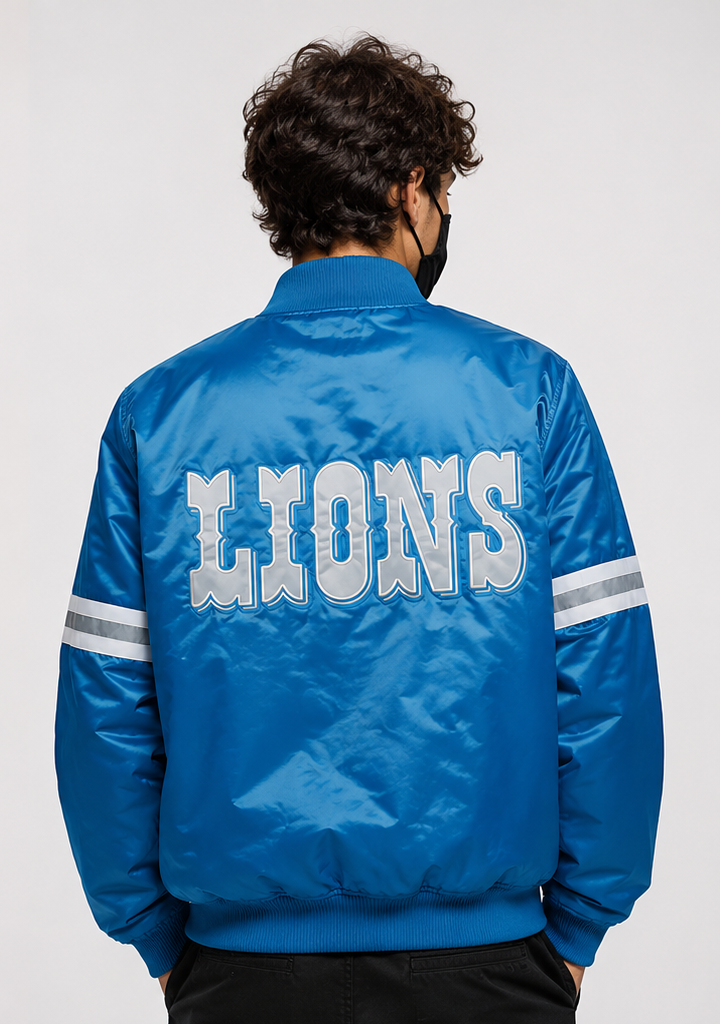 Person wearing a Detroit Lions blue 'LIONS' logo jacket on a white background