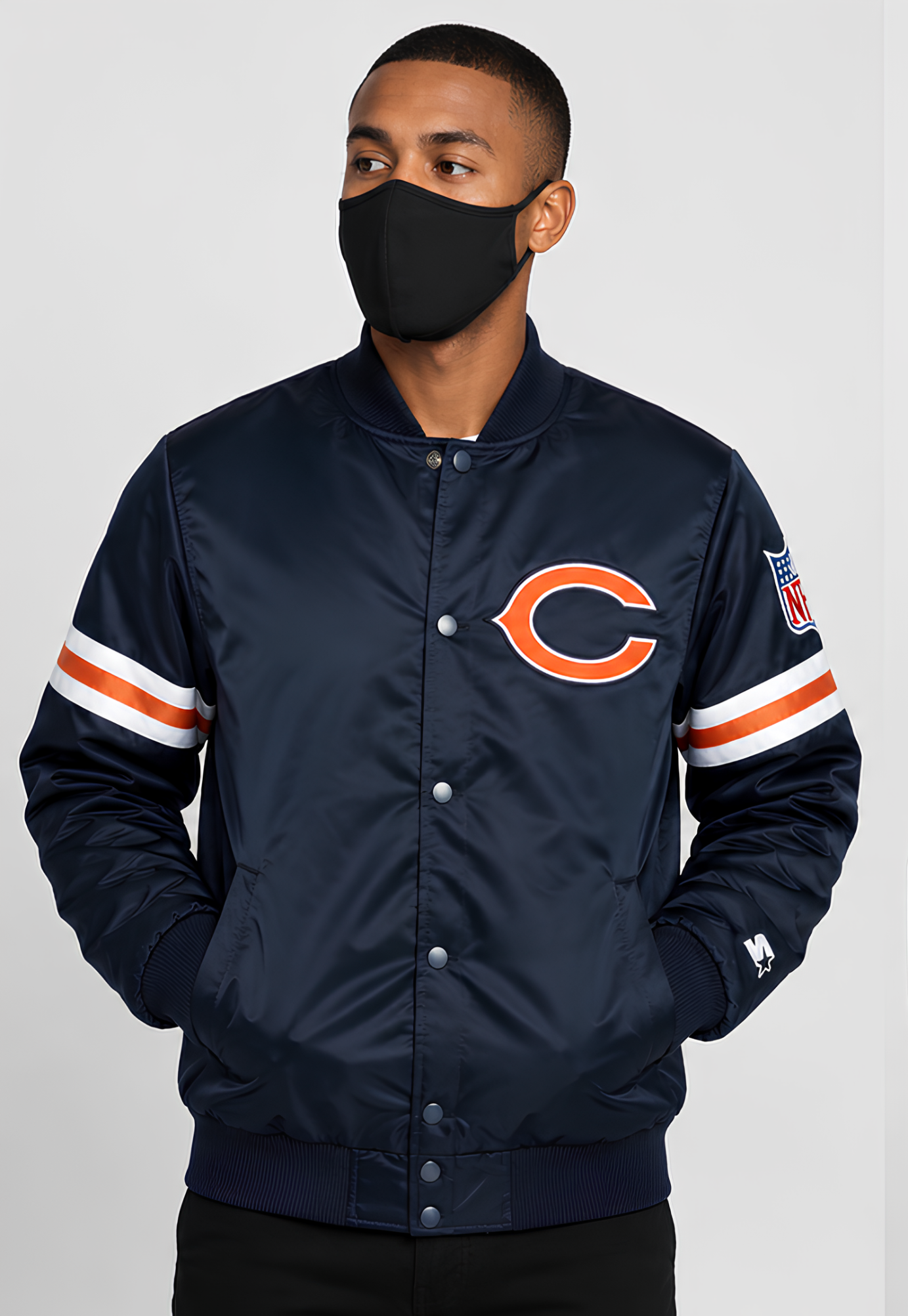 Person wearing a Chicago Bears Navy Satin jacket with a logo on a gray background
