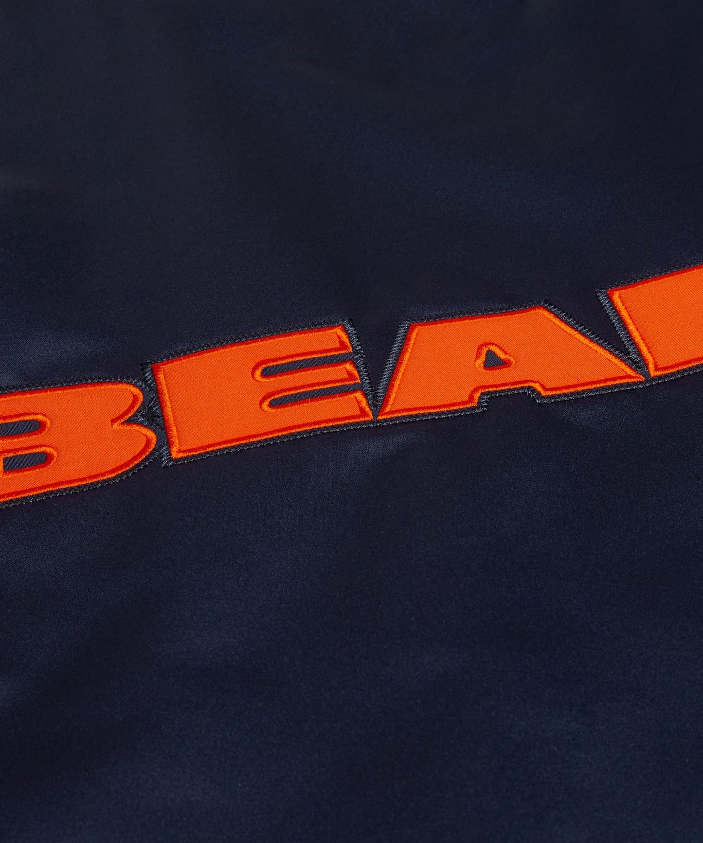 Navy blue fabric with orange 'BEAR' text