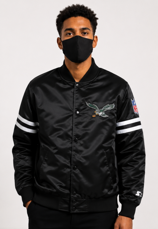 Person wearing a Philadelphia Eagles black satin jacket with a logo on a white background