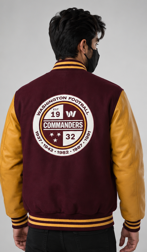 A man viewed from the back wearing a maroon and gold varsity jacket with a large circular 'Washington Football Club Commanders' patch on the back, set against a plain light gray studio background.