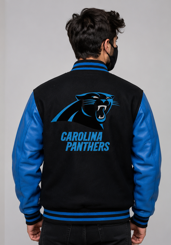 A man viewed from the back wearing a Carolina Panthers varsity jacket with a black fleece body, blue faux leather sleeves, and a large Carolina Panthers logo on the back.