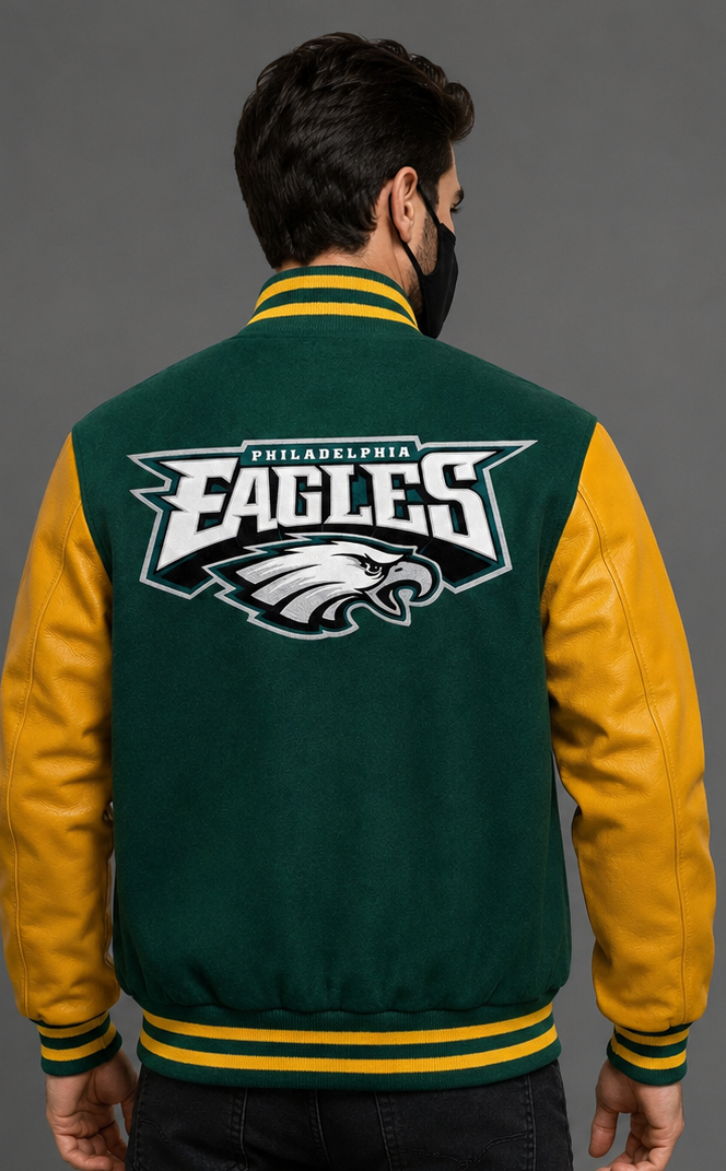 A man viewed from the back wearing a Philadelphia Eagles varsity jacket with a green and gold color-blocked design and a large team logo on the back.