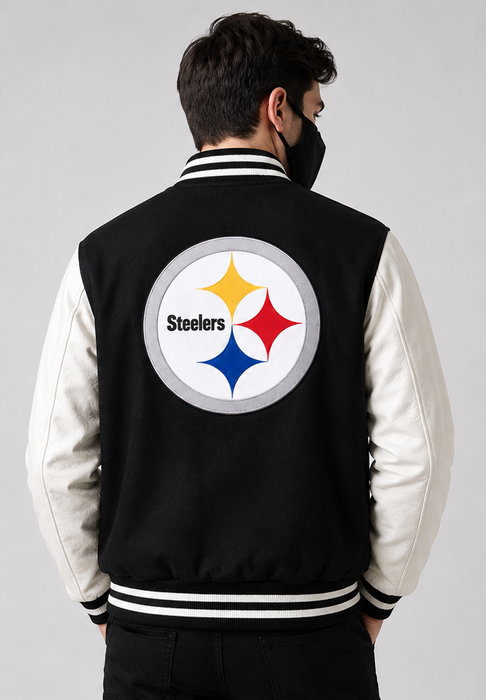 A man viewed from behind wearing a Pittsburgh Steelers varsity jacket with a black body, white sleeves, and a large Steelers logo on the back.