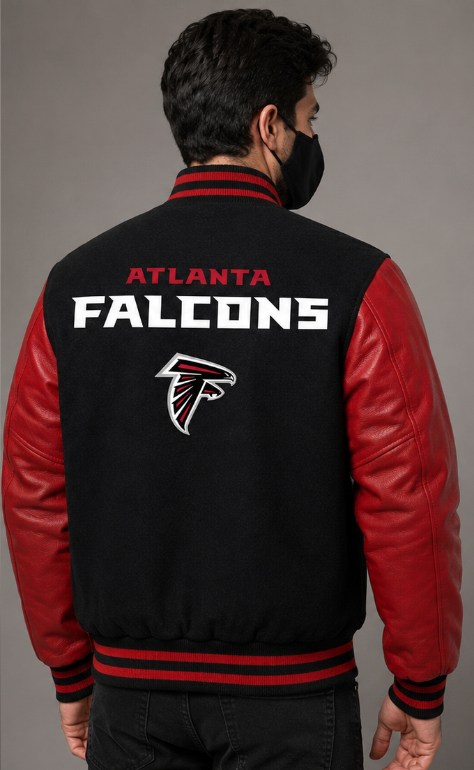 A man viewed from behind wearing a black and red Atlanta Falcons varsity jacket with 'ATLANTA FALCONS' and the team logo printed on the back, set against a plain gray studio background.